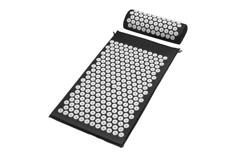 Acupressure mat and pillow set on white