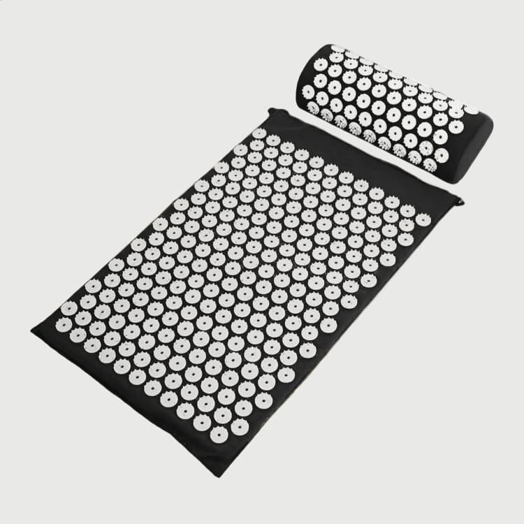 Acupressure mat and pillow, angled view on white
